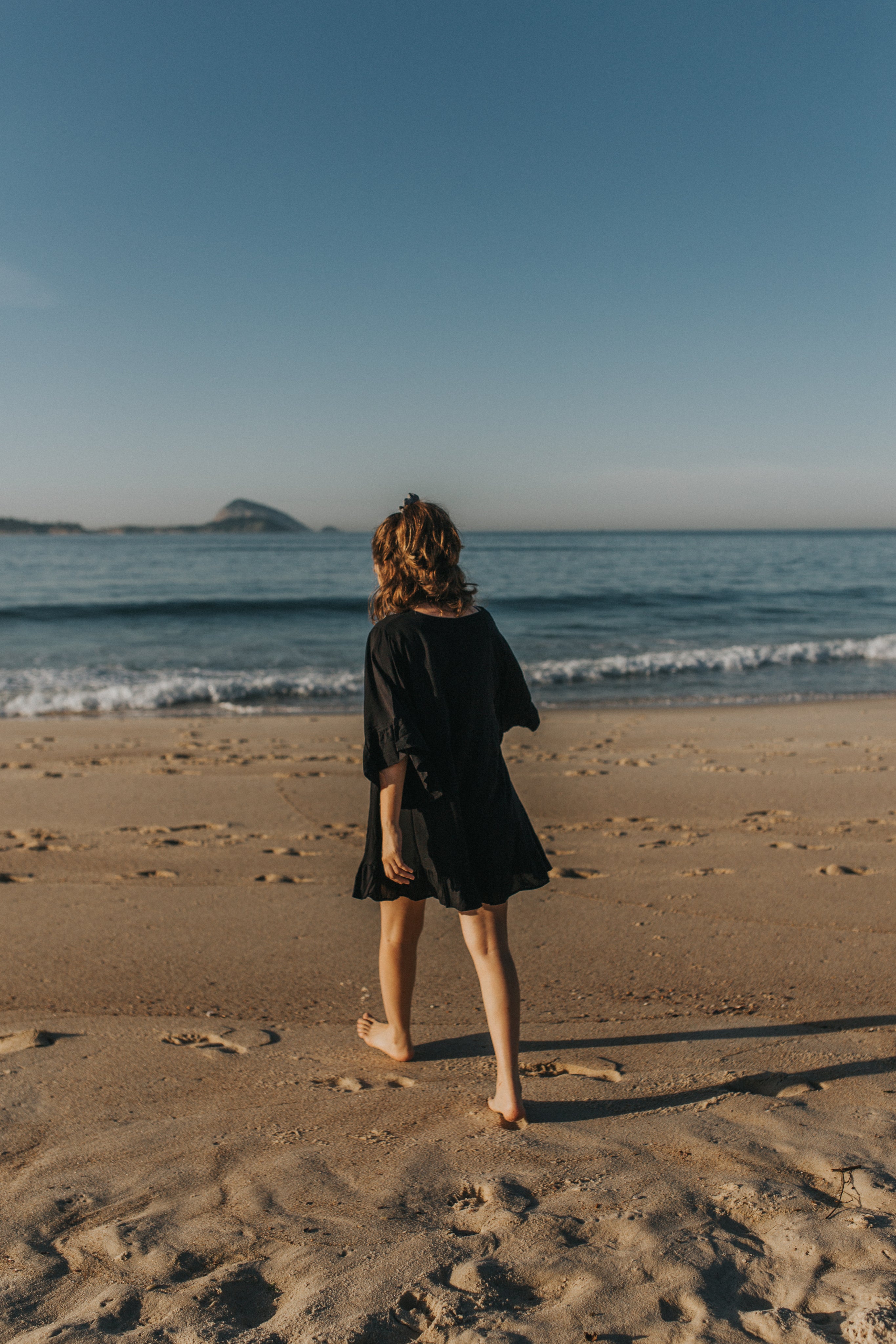 files/person-in-a-black-dress-walks-on-the-beach.jpg